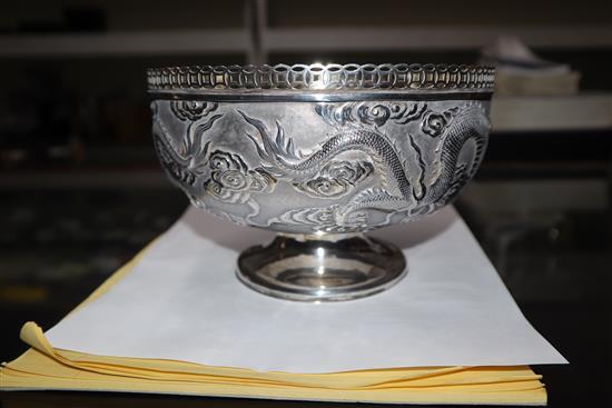 An early 20th century Chinese white metal pedestal bowl, embossed with dragons, 13.5 oz.